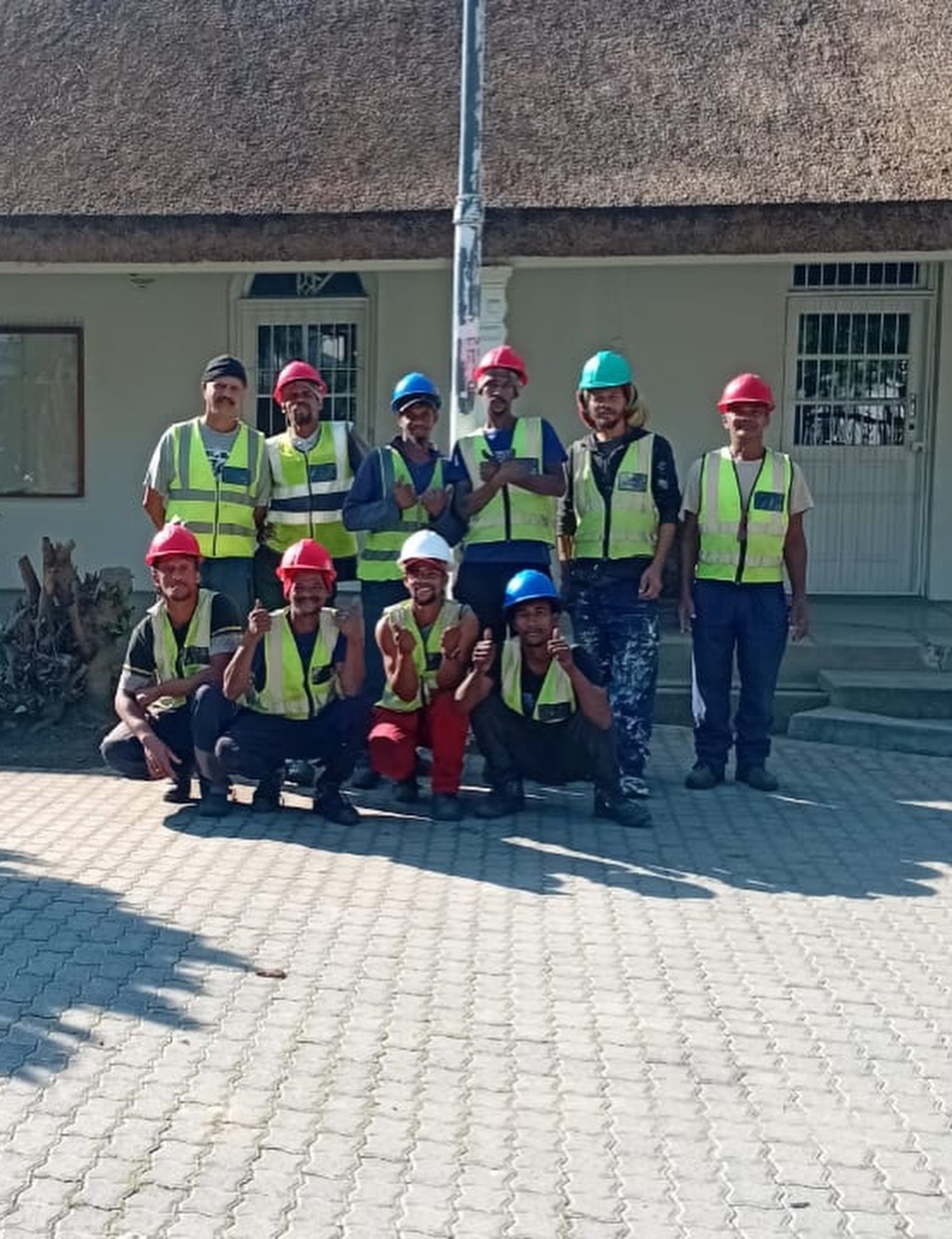 The Thatch Artisans team in safety vests and hard hats on site